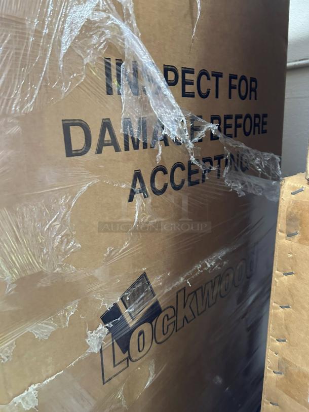 Unopened crate of Lockwood CA72-RR12-6 display cabinet. Visible label: "Inspect for damage before accepting." Pristine condition.