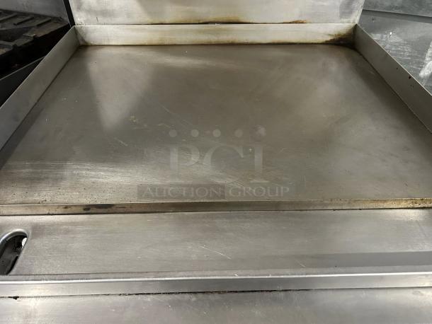 Garland G36-G36R 36" gas range with full griddle, excellent condition. Natural gas, tested and working. Stainless steel finish.