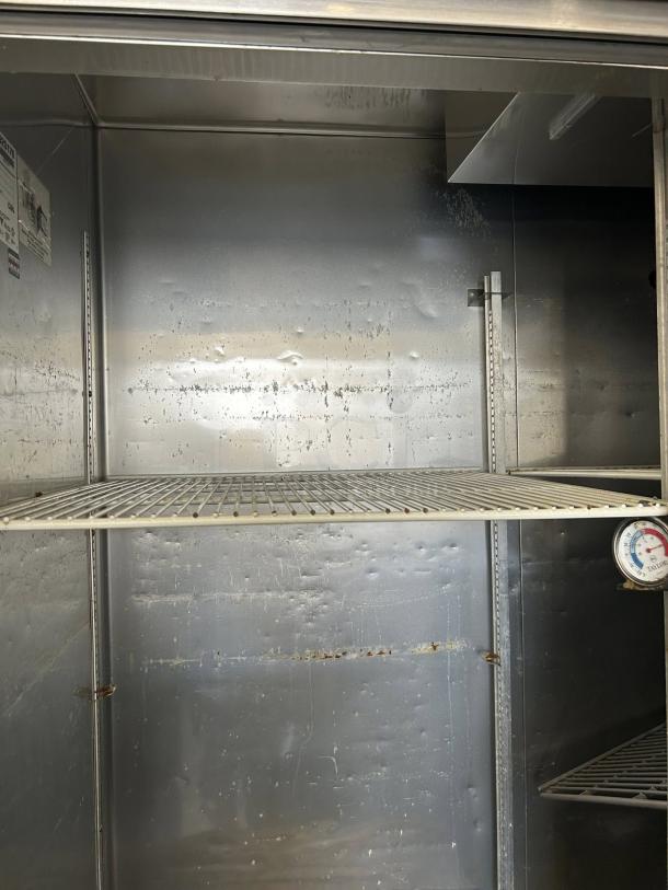 True T-72-HC three solid door reach-in refrigerator interior, showing wire shelves and dial thermometer. Tested, working condition.