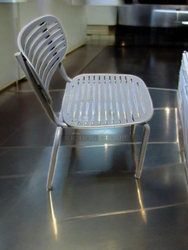 Lot of 7 blue slatted steel patio chairs by Commercial Outdoor Furniture, modern design, very good condition. Ideal for outdoor use.