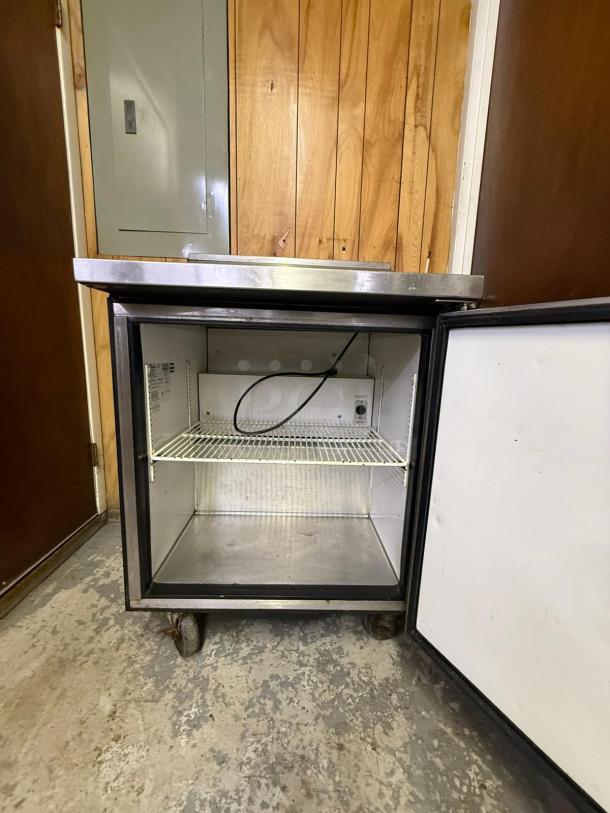 True TSSU-27-08-HC refrigerated sandwich prep table, right-hinged door, visible interior shelving, well-used condition.