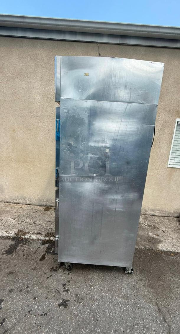 Continental 4 Door Reach-In Refrigerator 2R-HD, stainless steel, tested and working, minor surface wear, on casters.