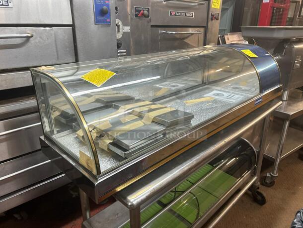 Brand new Counter Top refrigerated display case, still in box. Features a curved glass front and stainless steel finish.