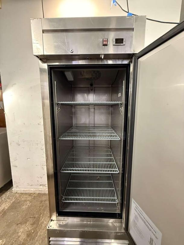 Dukers D28R 27 1/2" reach-in refrigerator with right hinge solid door, three wire shelves, and visible control panel.