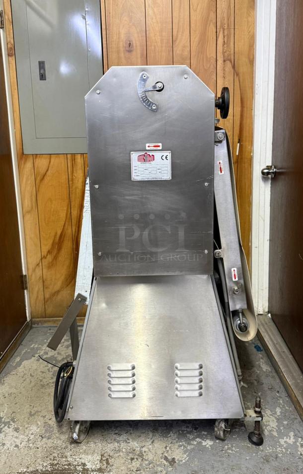CIM International 4000S dough sheeter, stainless steel, visible wear, model label indicating CE compliance, on caster wheels.
