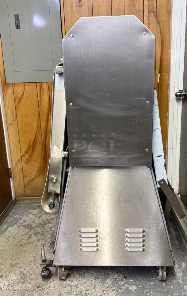 CIM International 4000S dough sheeter, stainless steel, visible wear, industrial kitchen equipment, on casters.