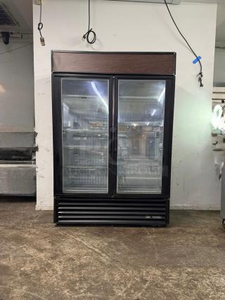 TRUE GDM-49-HC~TSL01 glass door merchandiser, 2 left hinge doors, black, used, 115v, spacious interior, branded base.