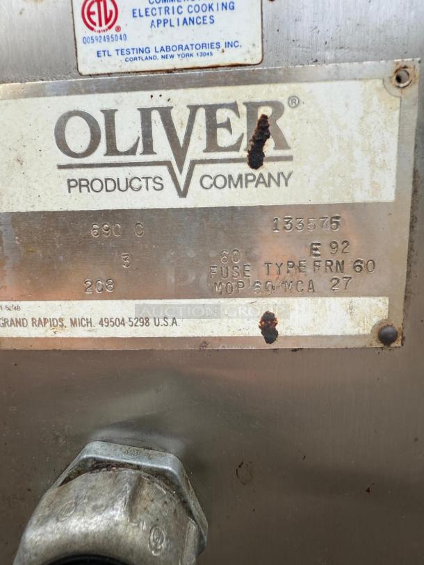 Oliver 690-NC2 commercial bread oven label, showing model, make, and electrical specifications. Some rust visible.
