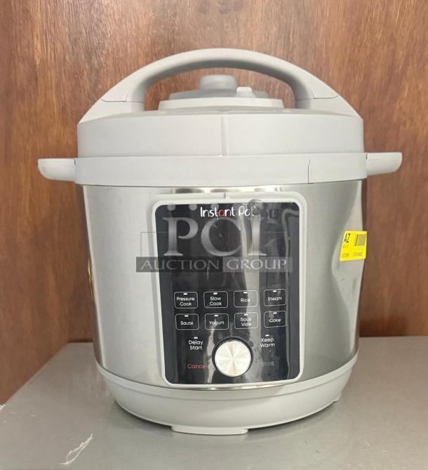 Instant Pot Pro Multi-Use Pressure Cooker, model LPZK0450032, in white. Features control panel and function buttons.