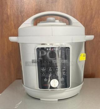 Instant Pot Pro Multi-Use Pressure Cooker, model LPZK0450032, in white. Features control panel and function buttons.