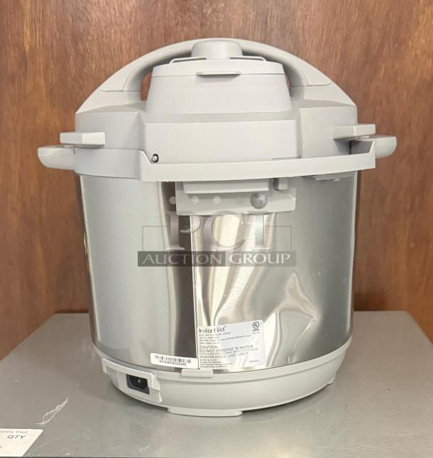 Instant Pot Pro Multi-Use Pressure Cooker, model LPZK0450032, in white with label indicating caution instructions.