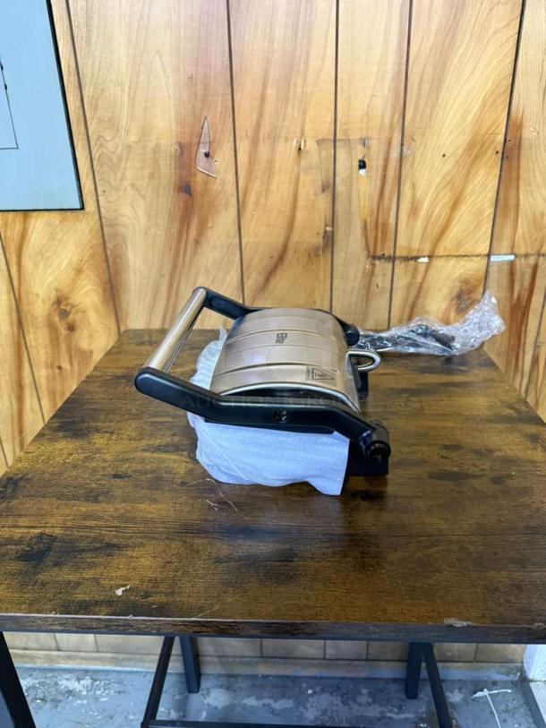 Elite Gourmet Nonstick Panini Press with floating hinge, shown closed. Features durable build, good condition.