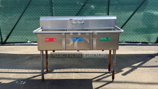 Stainless steel 3-compartment sink with labeled basins: wash, rinse, sanitize. Good condition, ideal for commercial use.