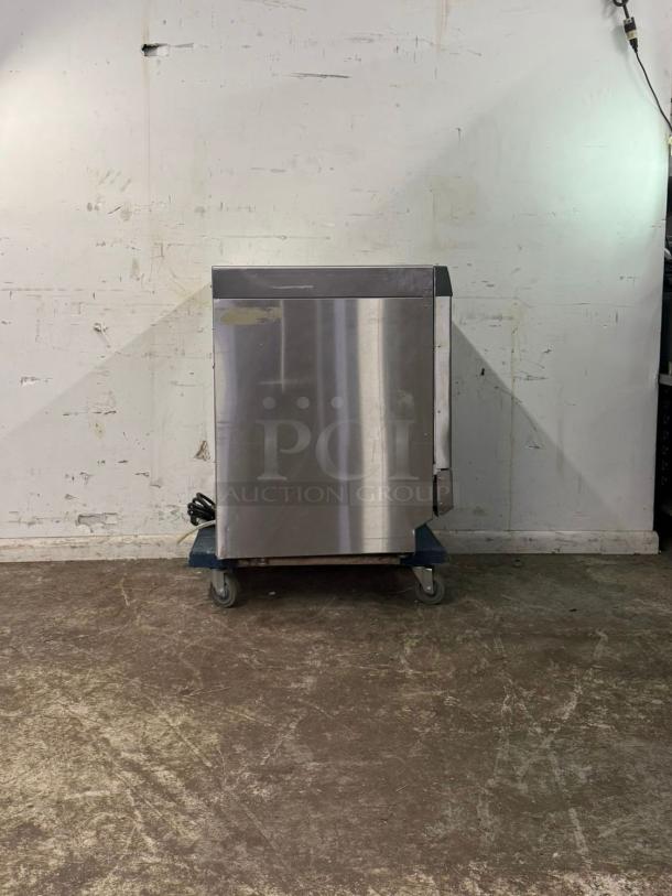 Labconco under counter dishwasher in stainless steel, used condition, placed on a dolly. Power cord visible.