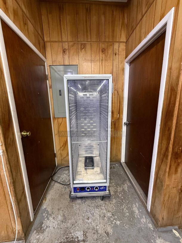 Full-size insulated proofer/warming cabinet, stainless steel, glass door, control knobs, on casters, used condition.