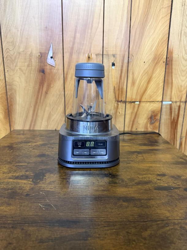 NINJA SS101 blender in excellent condition, 1200 peak watt motor, digital display, labeled settings for smoothies and sauces.