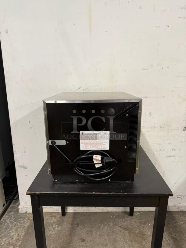 MENUMASTER RC17S2 19" commercial microwave, 1700W, shown from the back on a table. Tags show voltage information.