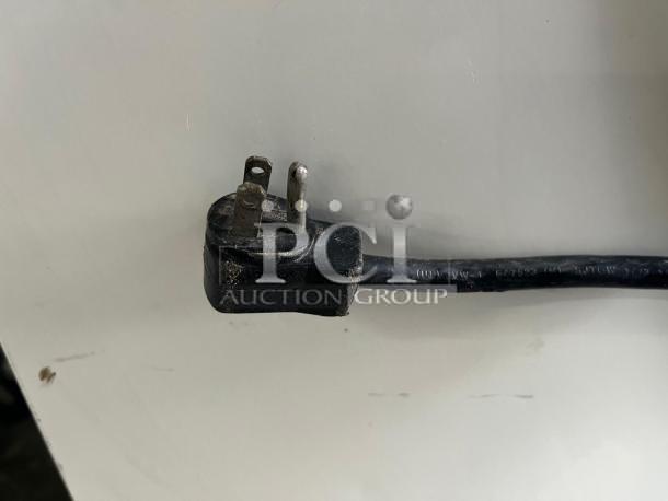 Alt Text: Power cord of Grab & Go Open Top Display Cooler. Cord appears intact. Cooler is tested and working, steel/white.