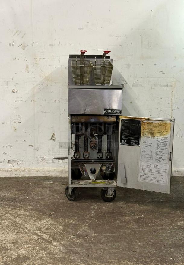 Dukers DCF4-NG 50 lb. Natural Gas Commercial Floor Fryer, 120,000 BTU, stainless steel, used, open door showing interior components.