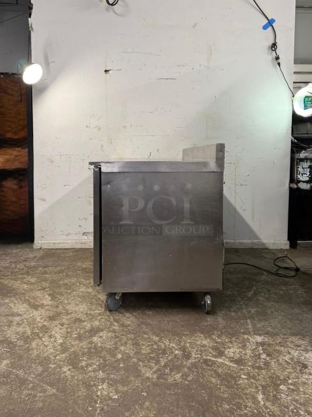 TRAULSEN UHT60-LR 60" undercounter refrigerator, stainless steel finish, two sections, wheels, 115v, used condition.