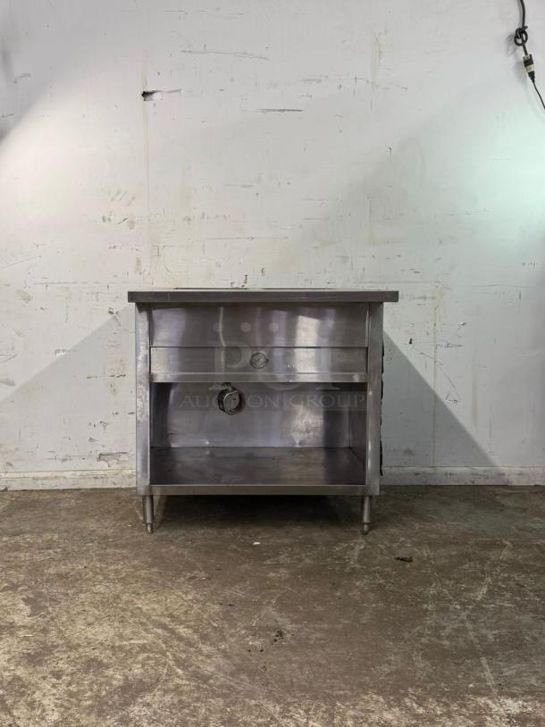 Stainless steel 3 well steam table, model 3 WELL, in good condition, featuring sturdy legs and an open lower shelf.