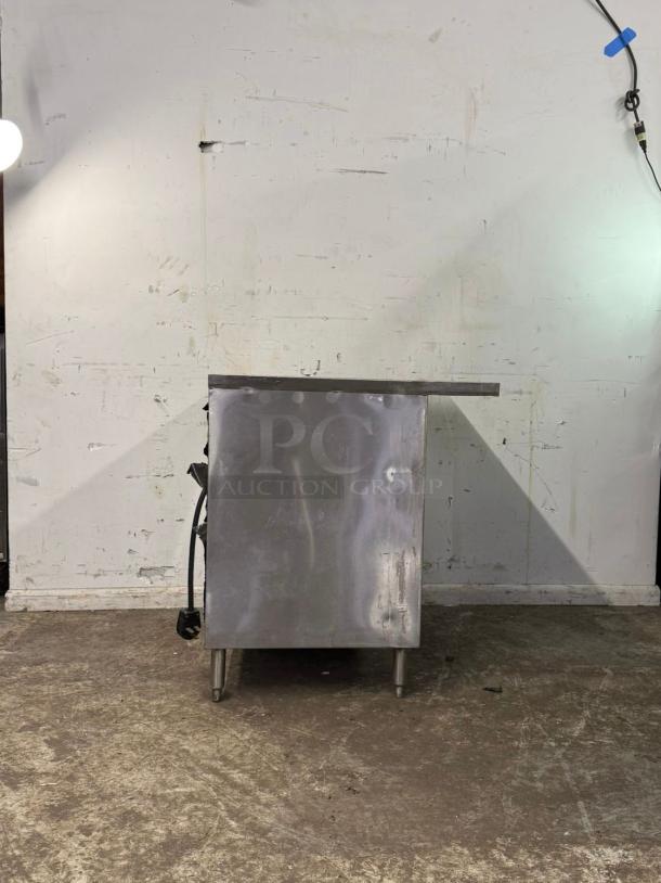 Stainless steel 3-well steam table, standing on metal legs. Some wear visible on the surface. Model: 3 WELL.