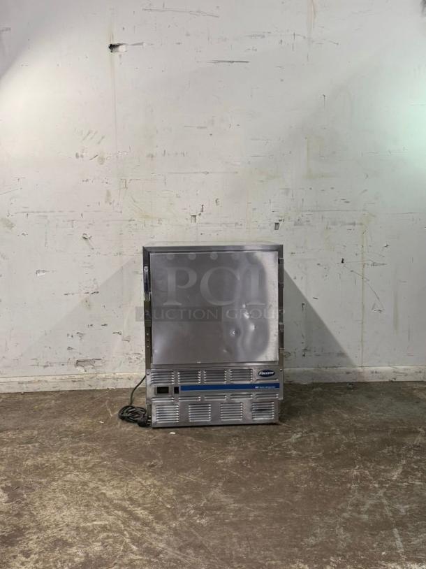 FOLLETT Performance Plus Undercounter Refrigerator, Model REV 4-ADA, right hinge, stainless steel, visible dents on door, power cord attached.