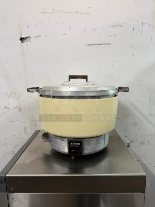 RINNAI 55-cup commercial rice cooker model RER55ASN, natural gas, on metal stand. Visible Rinnai label, good condition.
