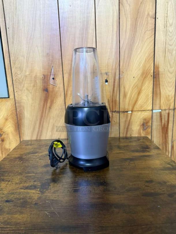 Ninja BL450C Nutri Pro blender, black/silver, 900W, 18 oz cup shown. Used, visible power cord. Ideal for juices, smoothies.