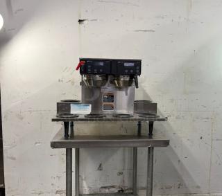 Brand new BUNN Axiom 0/6 Twin 12 Cup Automatic Coffee Brewer. Features 6 lower warmers, stainless steel build, and control panel.