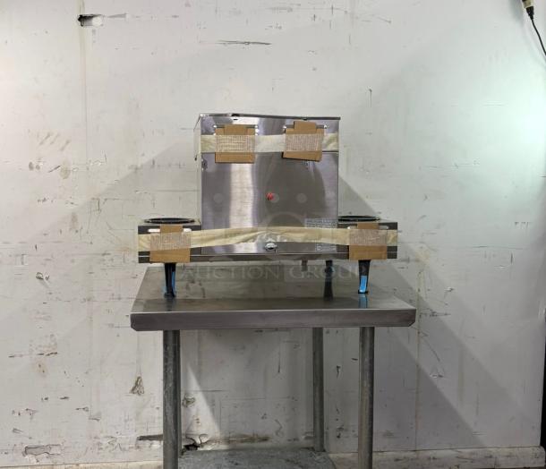 Brand new Bunn Axiom 0/6 Twin 12 Cup Automatic Coffee Brewer, stainless steel, with 6 lower warmers, labeled for shipping.