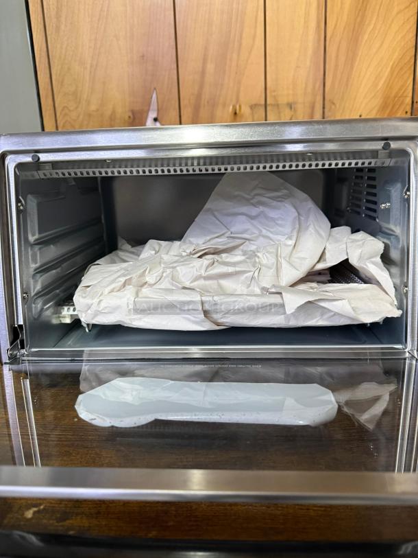 Hamilton Beach 4-slice toaster oven, stainless steel, 5 cooking modes, interior view, new condition, two rack positions visible.