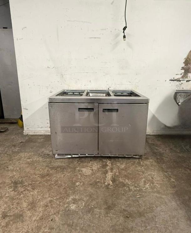 Delfield 4448NP-18M 48" refrigerated sandwich prep table, two doors, stainless steel, good condition.