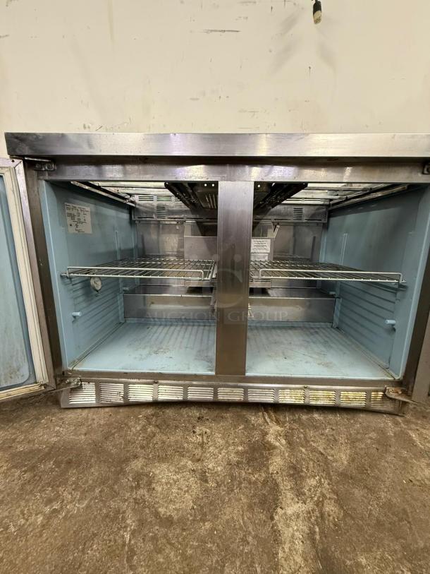 Delfield 4448NP-18M 48" 2 Door Refrigerated Sandwich Prep Table, stainless steel, interior view, fair condition.