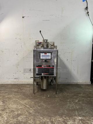 WELLS KFC pressure fryer, stainless steel, digital controls, lever handle, on casters, visible warning labels, used condition.