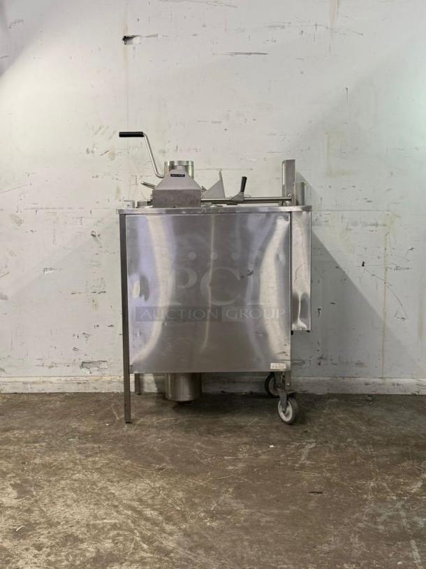 Wells KFC pressure fryer, stainless steel, industrial kitchen equipment, mounted on wheels, sturdy condition.