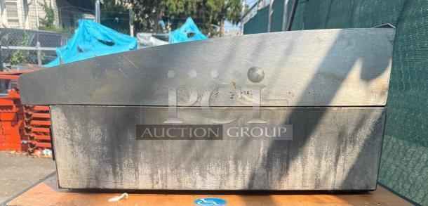 Toastmaster 36" gas griddle; stainless steel, thermostatic control, used condition, rust visible, outdoor setting.