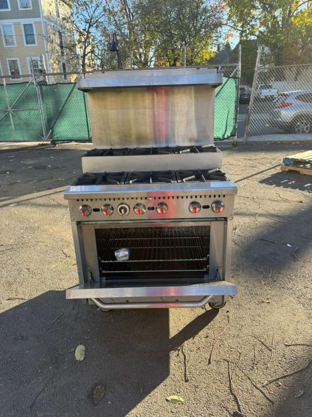 Pro Series 36" gas range with 6 burners, step-up design, standard oven, and over shelf in good condition.