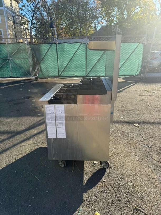 Pro Series 36" gas range with 6 burners, step-up design, standard oven, and over shelf, in good condition. Labels visible on side.