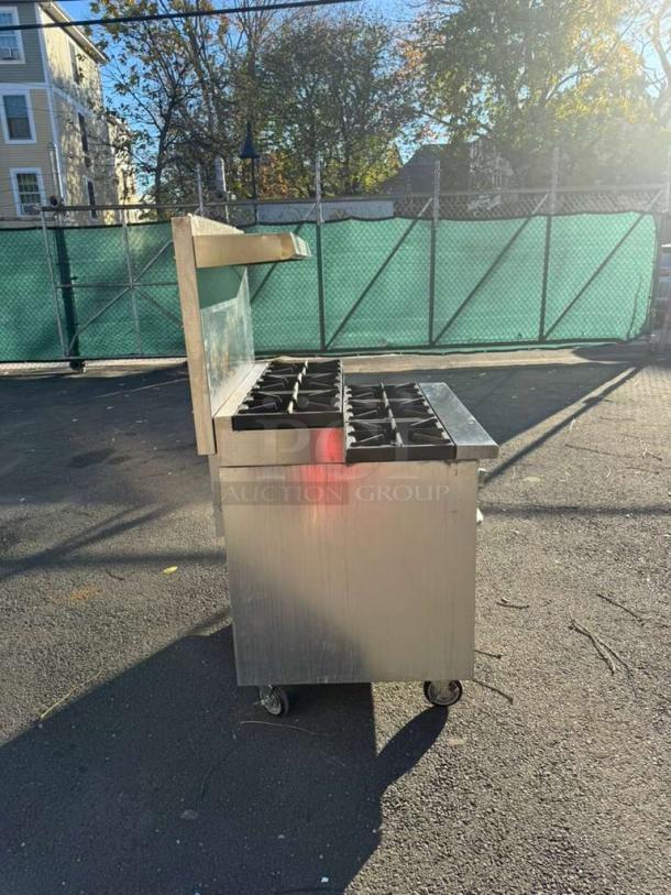 Pro Series 36" gas range with 6 burners, standard oven, and overshelf; on wheels for mobility; clean condition.