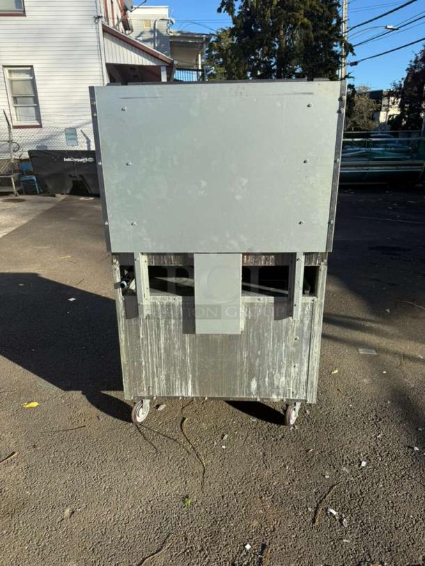 Pro Series 36" gas range, 6 burner, step-up design with standard oven and overshelf. Visible wear, outdoor setting.