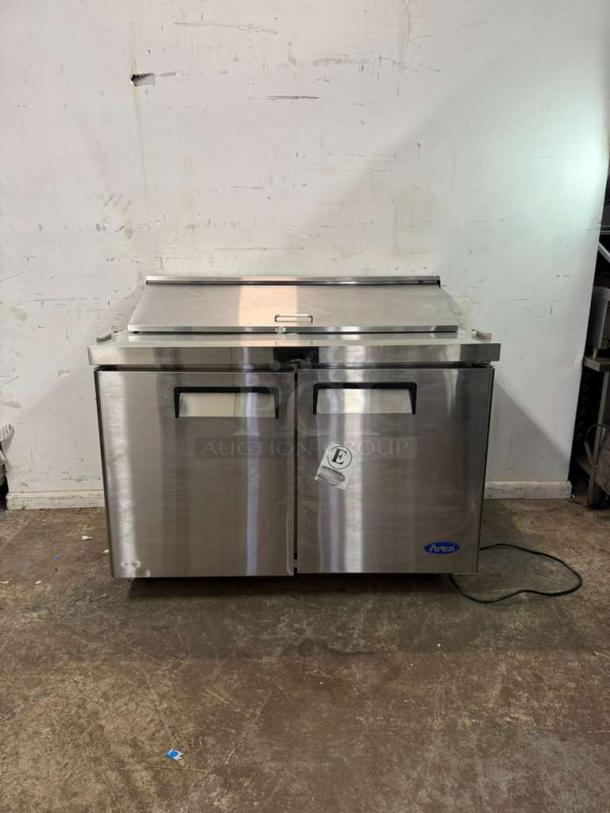 Brand new Atosa MSF8302GR 48" refrigerated sandwich prep table, two hinged doors, includes (12) 1/6 size pans, minor dents.