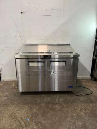 Brand new Atosa MSF8302GR 48" refrigerated sandwich prep table, two hinged doors, includes (12) 1/6 size pans, minor dents.