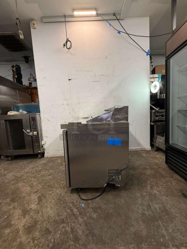 Brand new Atosa MSF8302GR refrigerated sandwich prep table, 48" wide, two hinged doors, 12 1/6 size pans, visible dent.