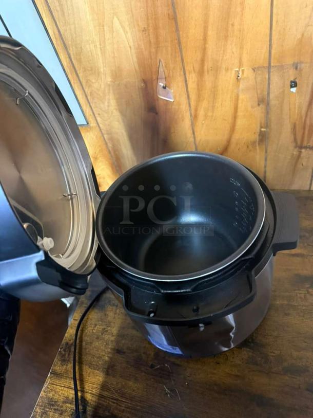 INSIGNIA 6-Quart Stainless Steel Pressure Cooker, Model MC60SSG, open lid, black finish, excellent condition.