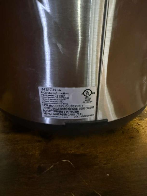 Insignia™ 6-Quart Stainless Steel Pressure Cooker, Model MC60SSG, features label detailing power and usage instructions.