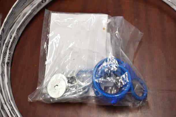 Plastic bag containing a blue wire loop, metal disc, and paper. Possibly parts for Henny Penny fryer.
