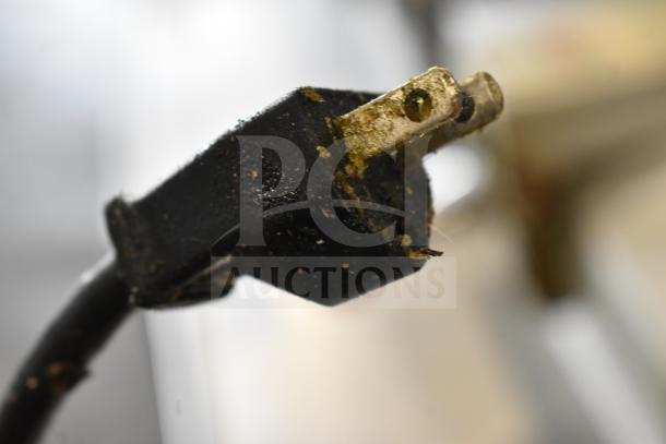 Close-up of a worn plug showing grime and wear, possibly from a commercial appliance like the Henny Penny 600 Fryer.