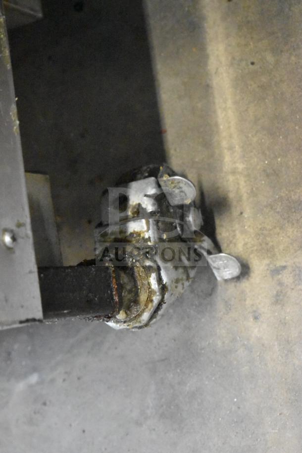 2022 Henny Penny 600 pressure fryer caster in worn condition, showing metal casters and attachment to fryer base.