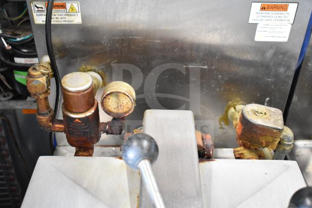 2021 Henny Penny 600 pressure fryer, natural gas, commercial casters, 80,000 BTU. Visible wear; warning labels shown.